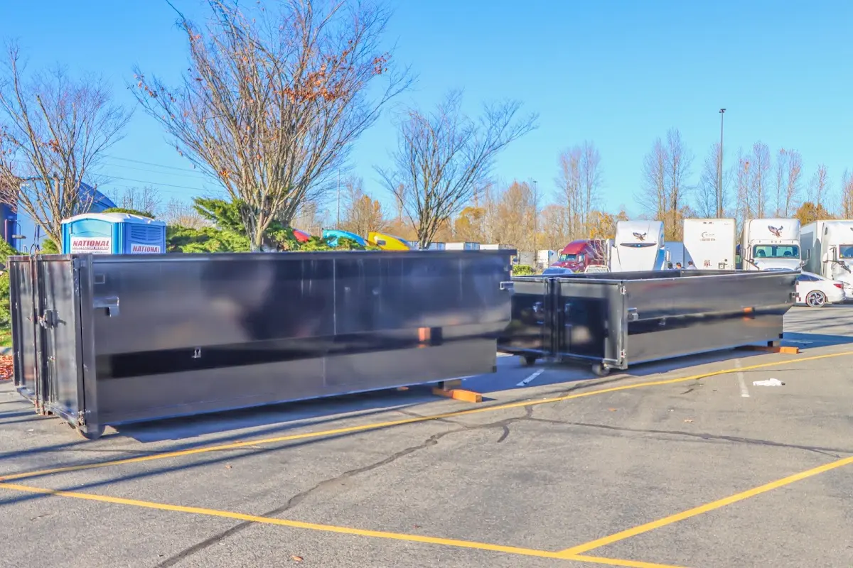 Professional dumpster rental service with roll-off container on residential driveway in Shelton